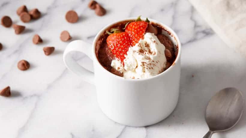 keto chocolate mug cake topped with whipped cream