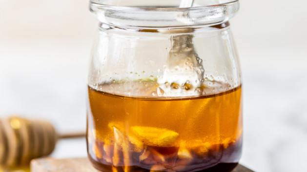 small glass jar with asian salad dressing and a fork