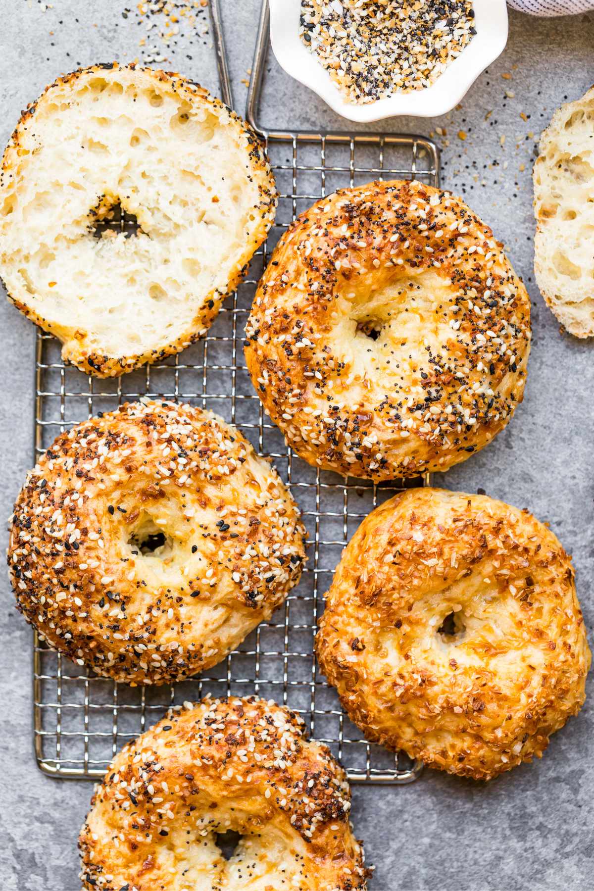 Baked protein bagels with cottage cheese on a cooling rack.