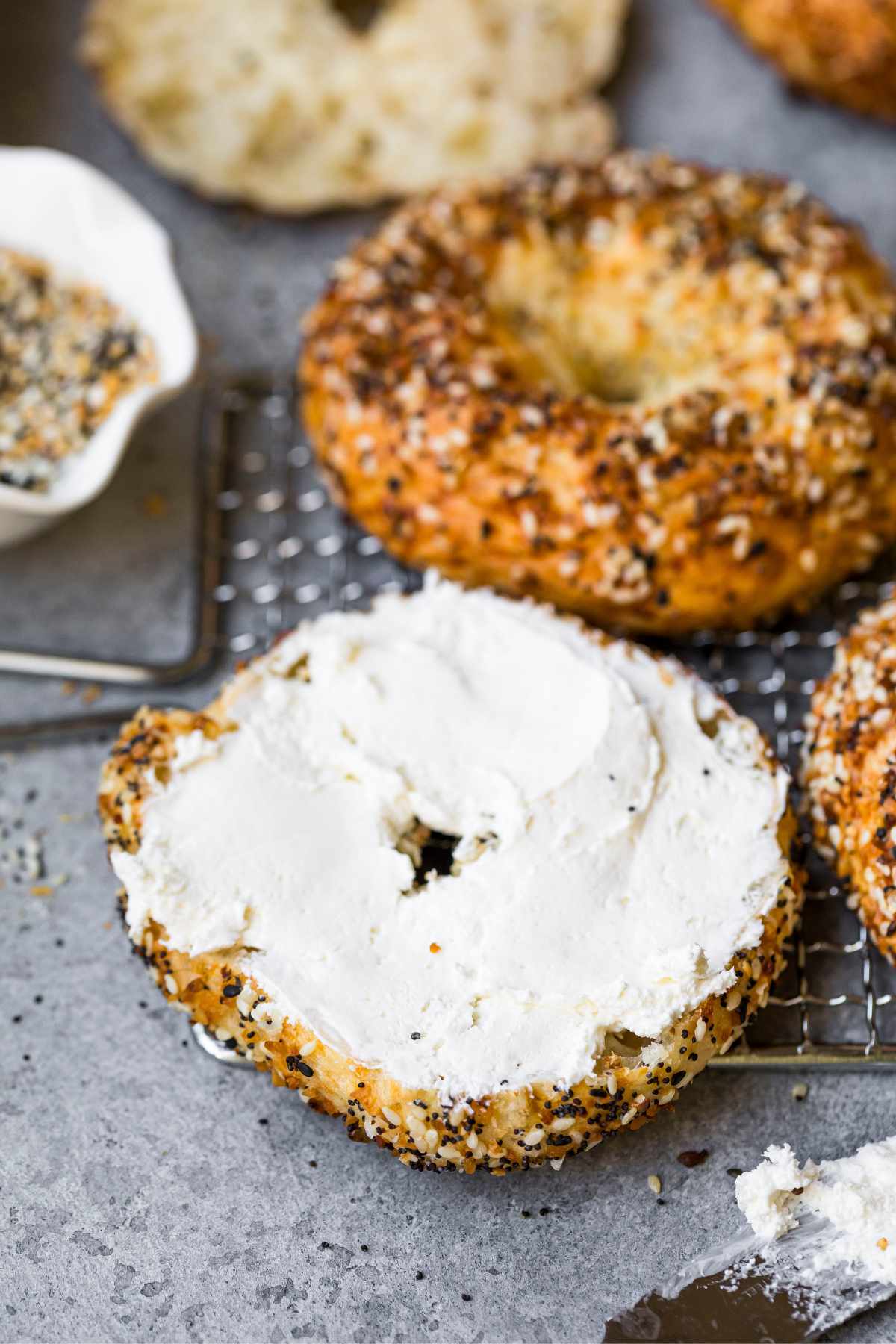 Bagel cut in half and topped with cream cheese.