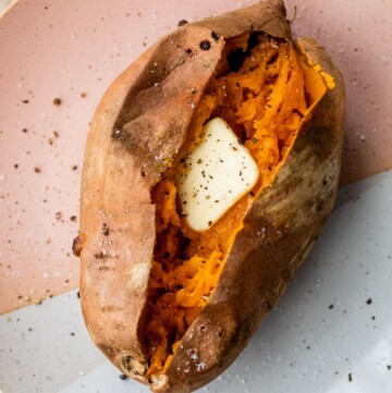 Baked sweet potato topped with a pat of butter.