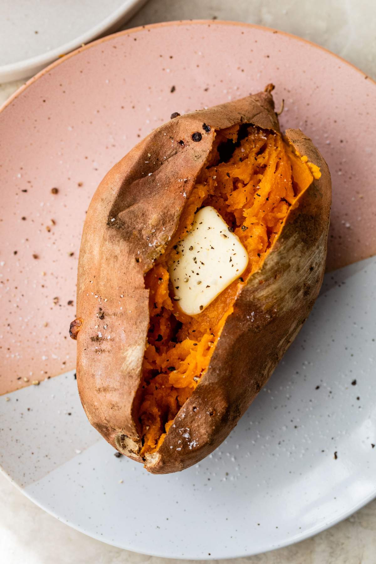 Baked sweet potato topped with a pat of butter.