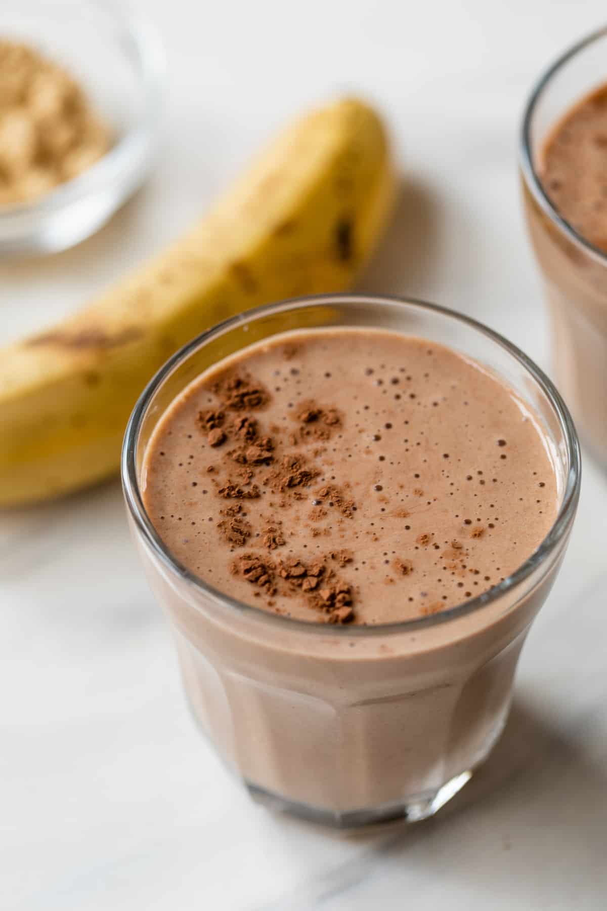 banana pb fit powder and chocolate protein shake in a glass