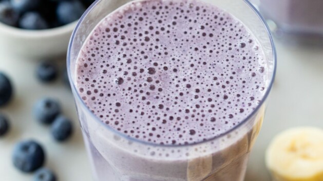 Glass with a blueberry banana smoothie.