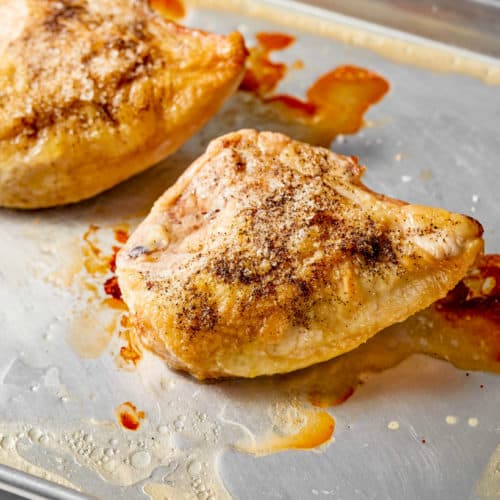 baked bone-in chicken breast on a baking sheet