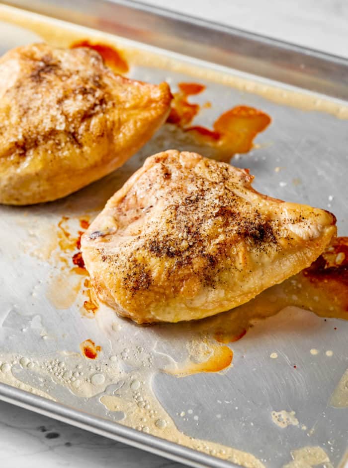 baked bone-in chicken breast on a baking sheet