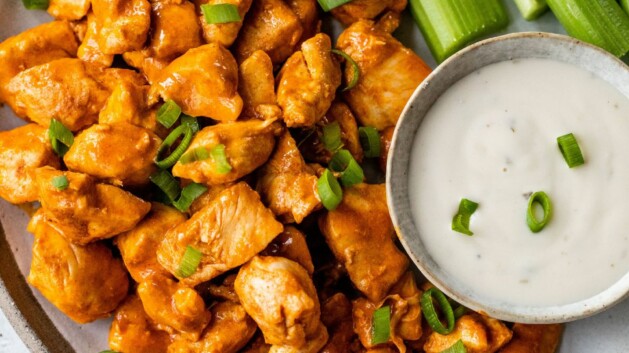 Buffalo chicken bites served with ranch dressing and celery sticks.