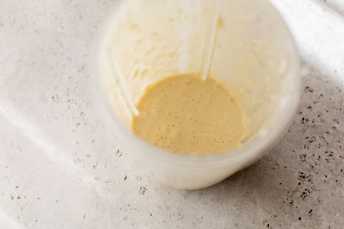 Caesar dressing mixed in a blender.