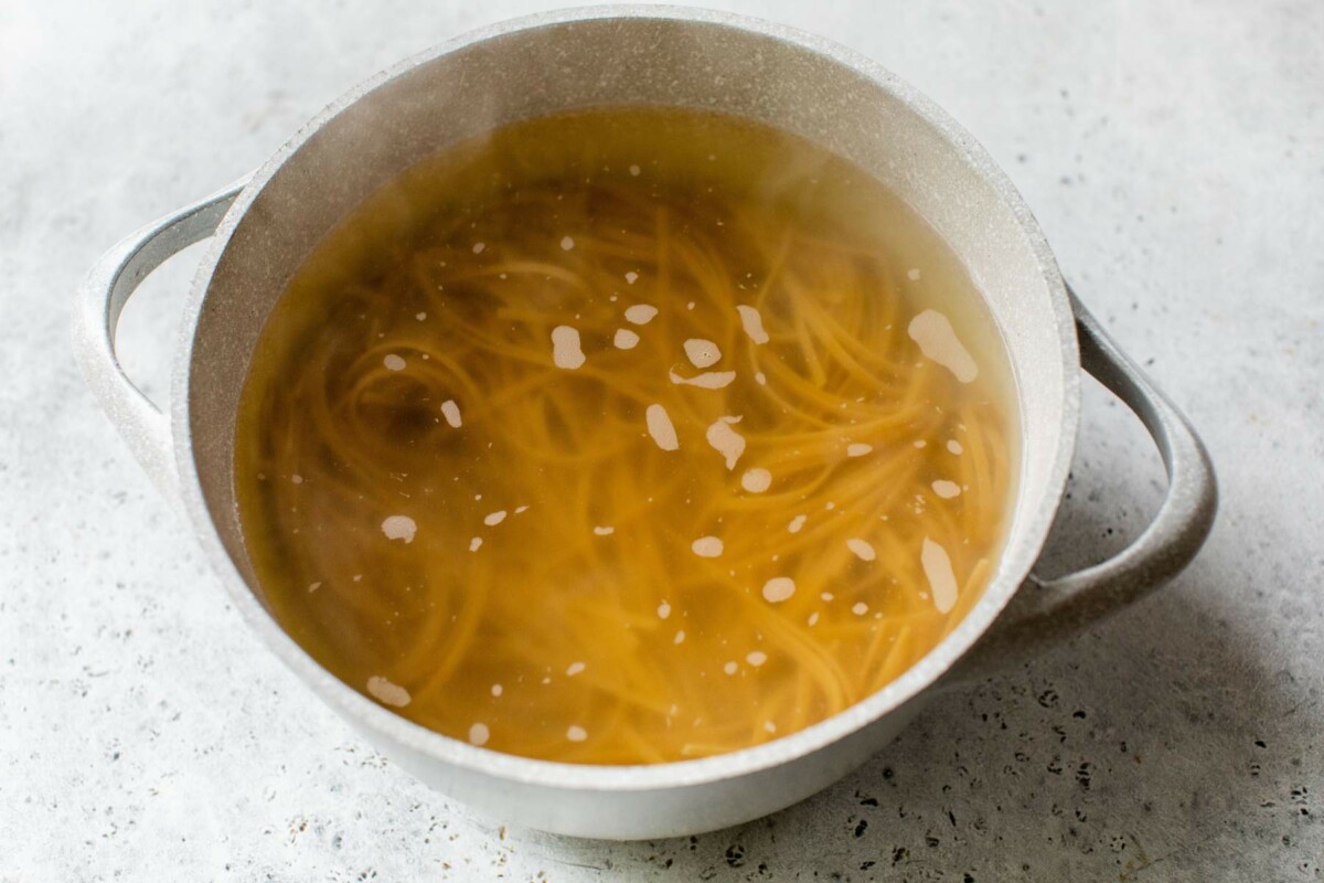 Boiling pasta in a pot with water.