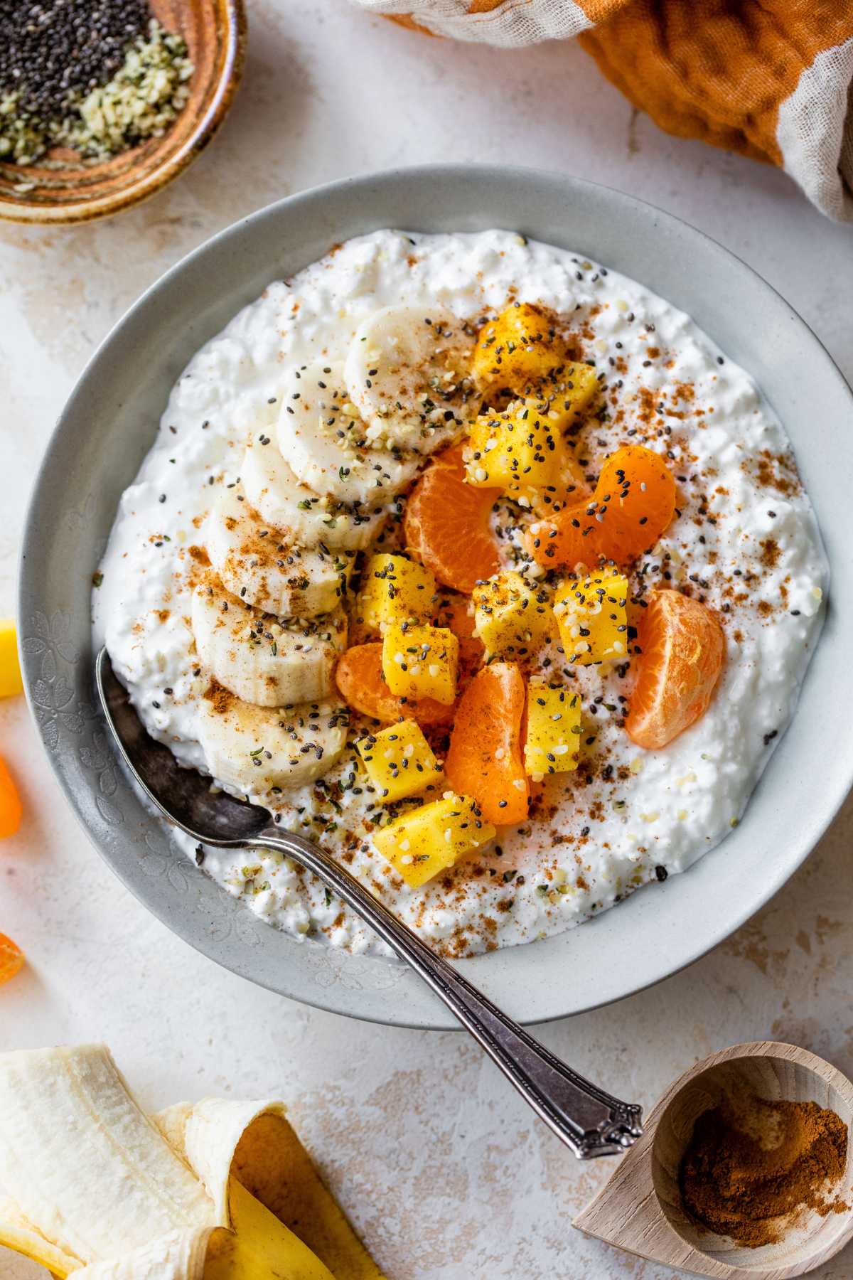 Cottage cheese topped with mango, banana slices, and clementine.