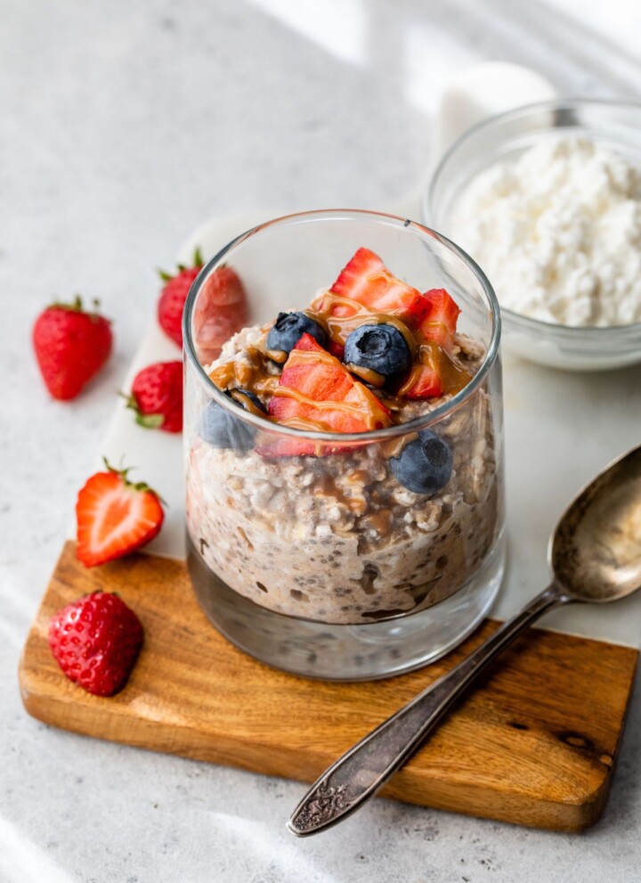 Overnight oats with cottage cheese topped with berries and almond butter.