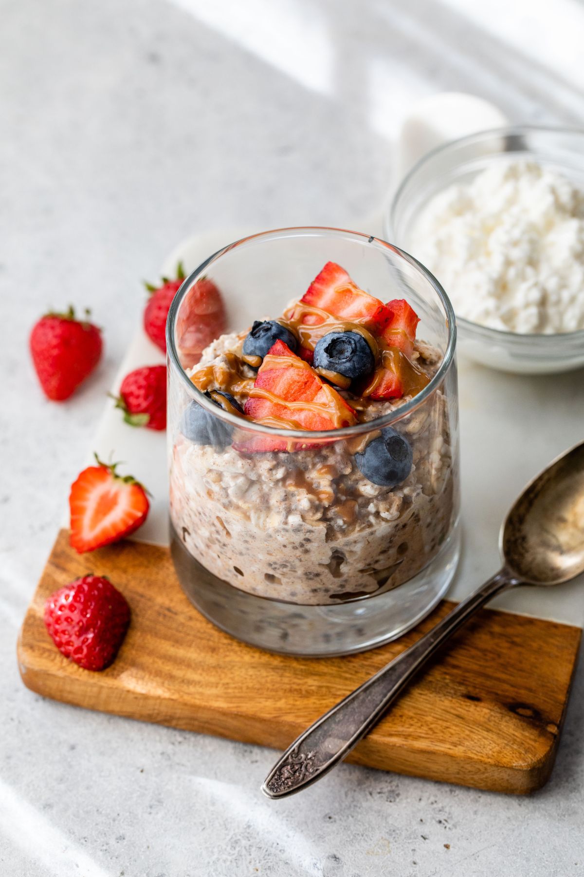 Overnight oats with cottage cheese topped with berries and almond butter.