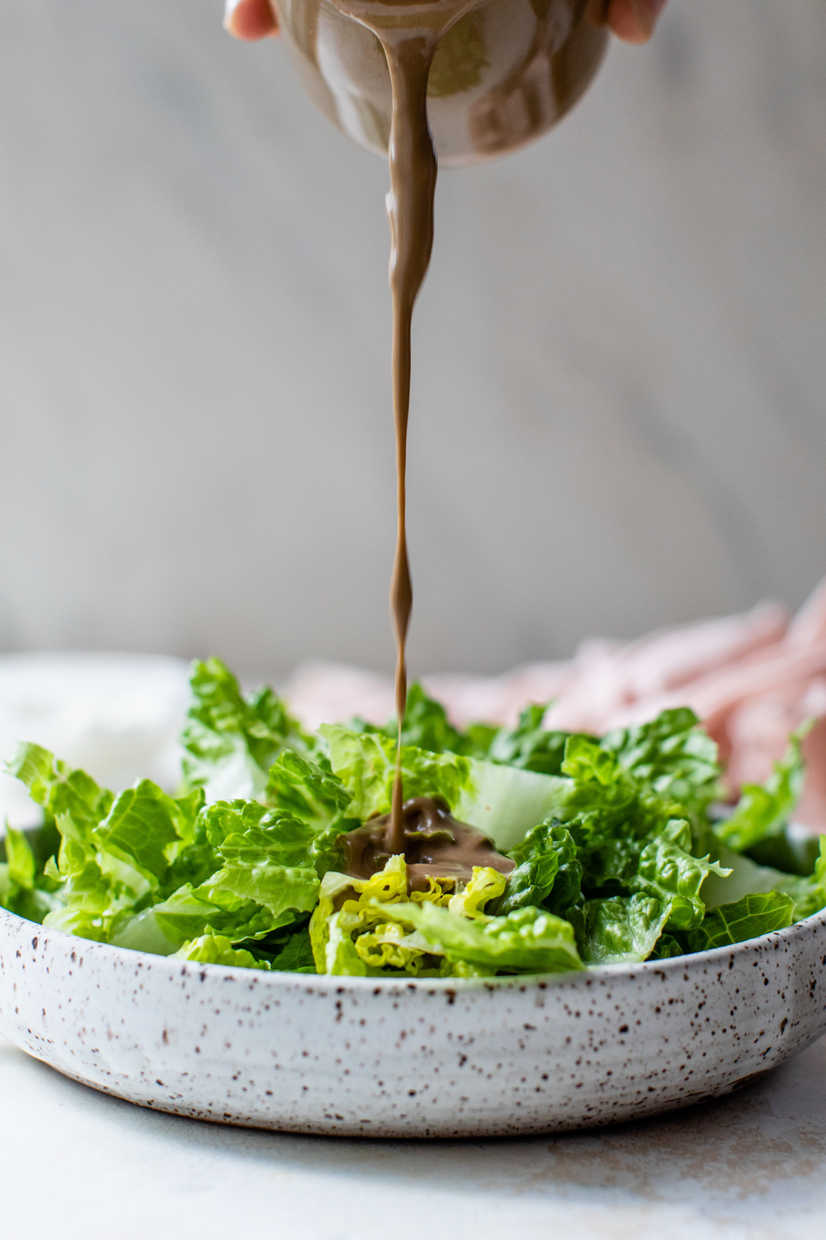 balsamic dressing poured over salad greens