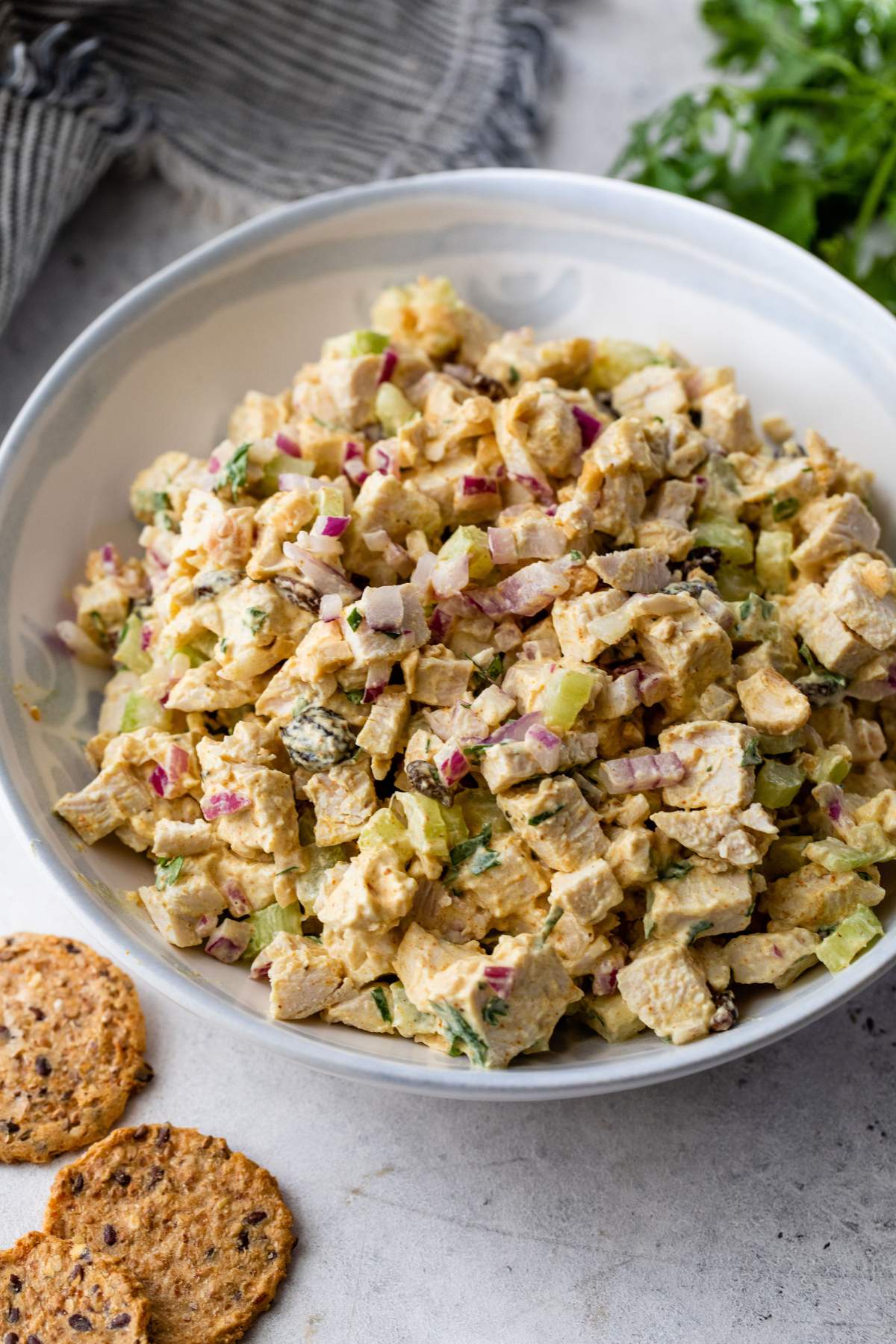 Curry chicken salad in a white bowl.
