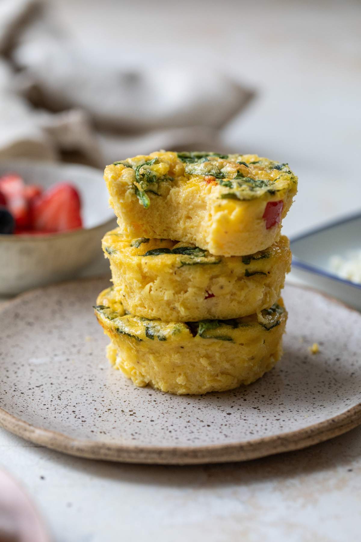 Three egg bites stacked on a plate.