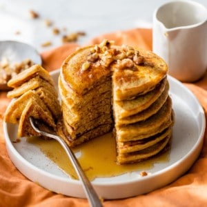 pumpkin protein pancakes being eaten with a fork