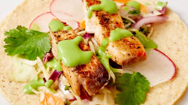 open-faced fish taco on white plate
