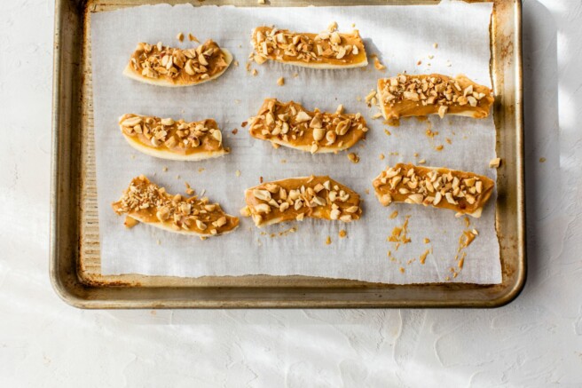 Peanut butter spread on banana slices.