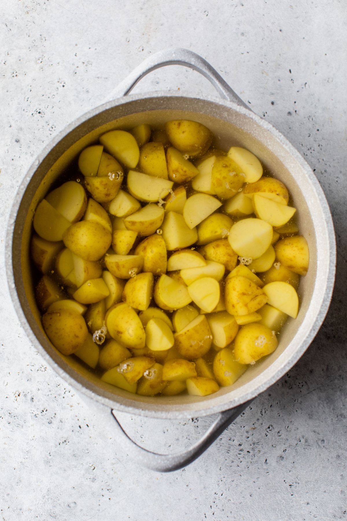 Cooked red potatoes in a large bowl.