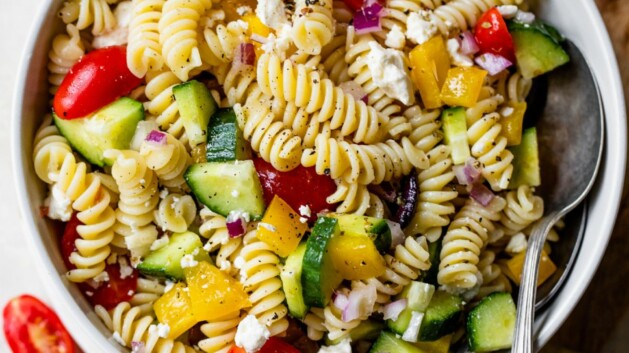 Greek pasta salad served in a white bowl.