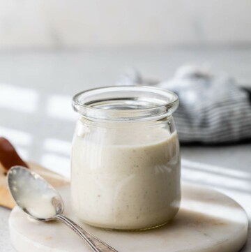 Greek yogurt caesar dressing in a small glass jar.
