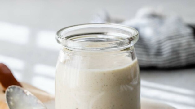 Greek yogurt caesar dressing in a small glass jar.