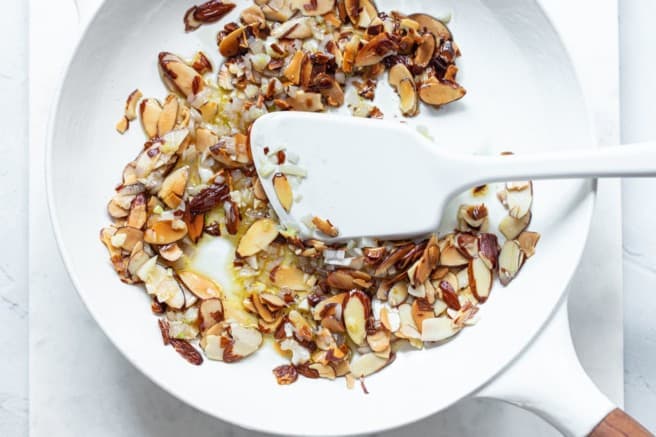 cooking almonds and shallots in a large skillet
