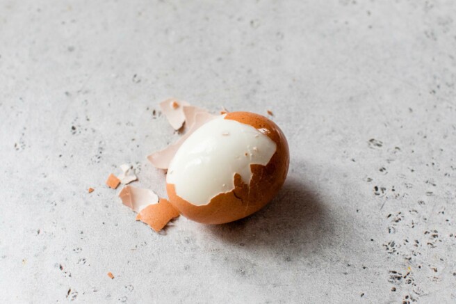 Partially peeled boiled egg.