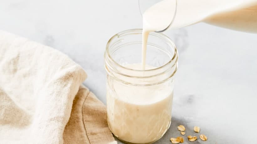 oat milk pouring into cup