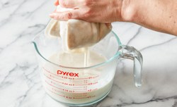 milk dripping through nut bag