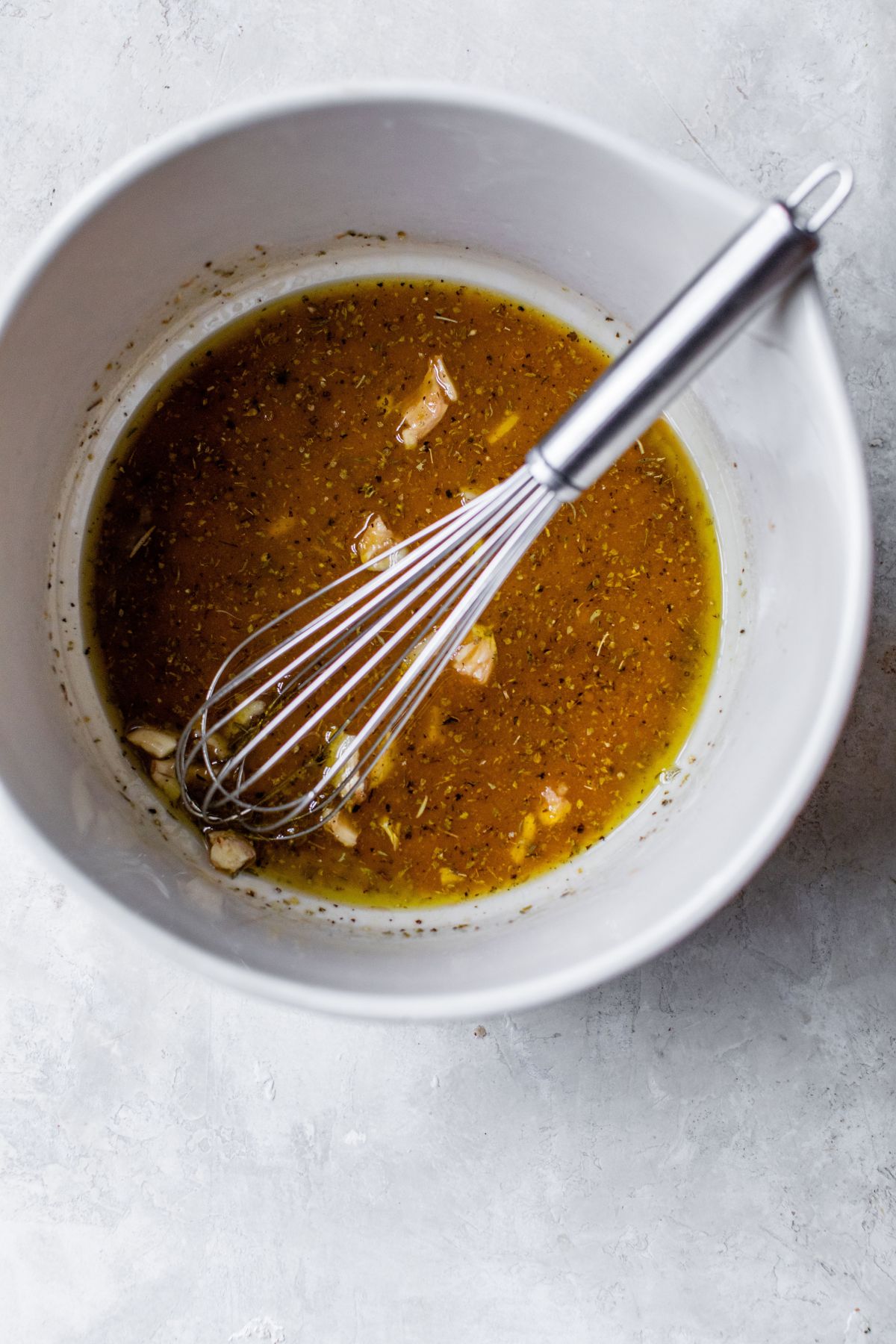 Whisking dressing in a bowl.
