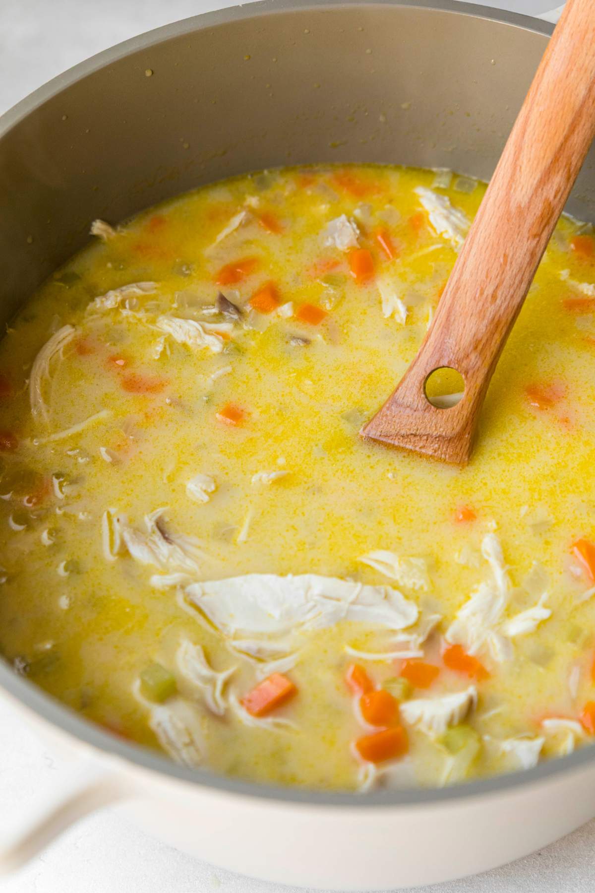 Stirring lemon chicken soup with orzo.