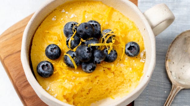 lemon mug cake topped with fresh blueberries
