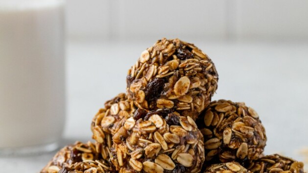 Oatmeal raisin energy bites stacked on a plate.