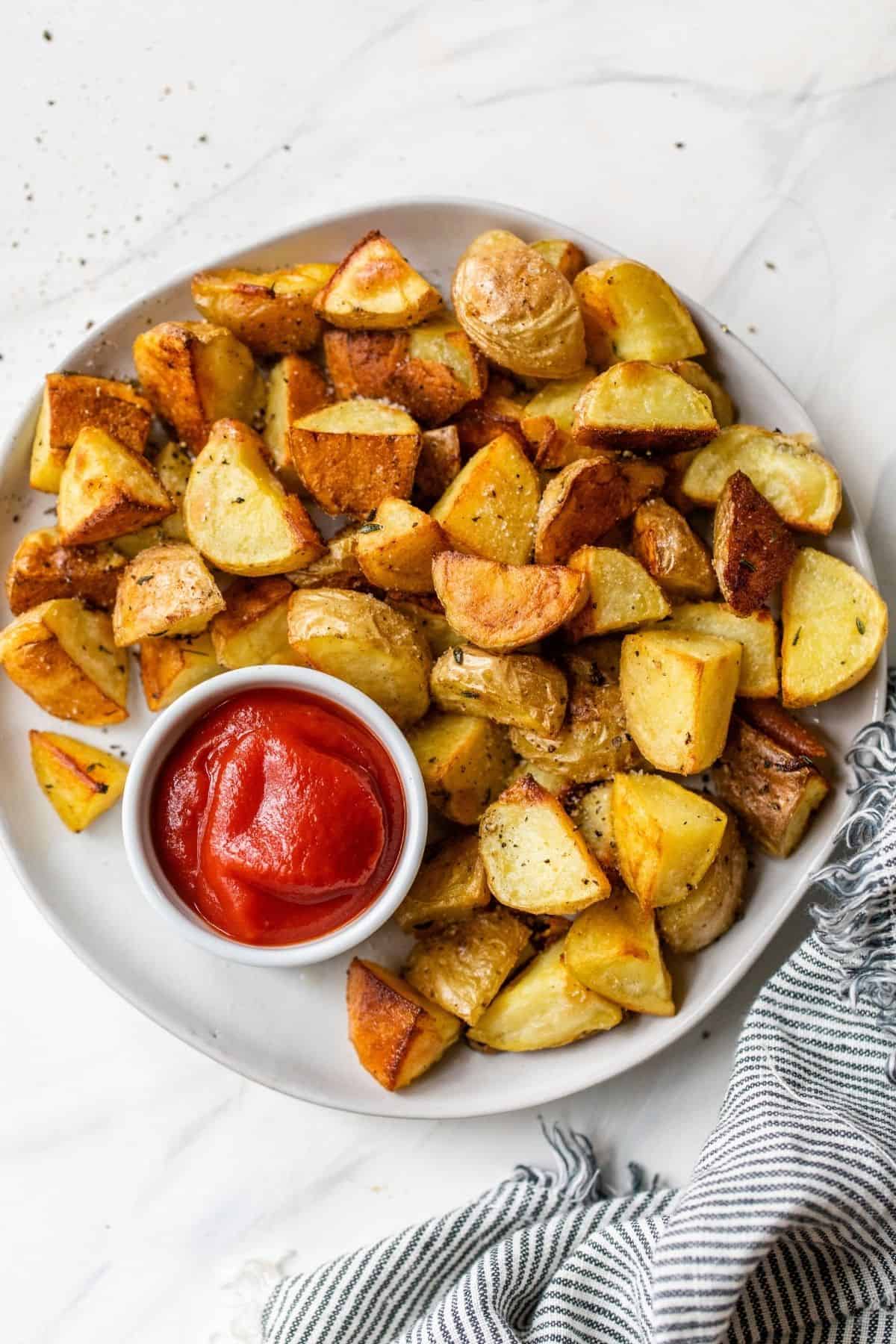 oven roasted potatoes served with a side of ketchup