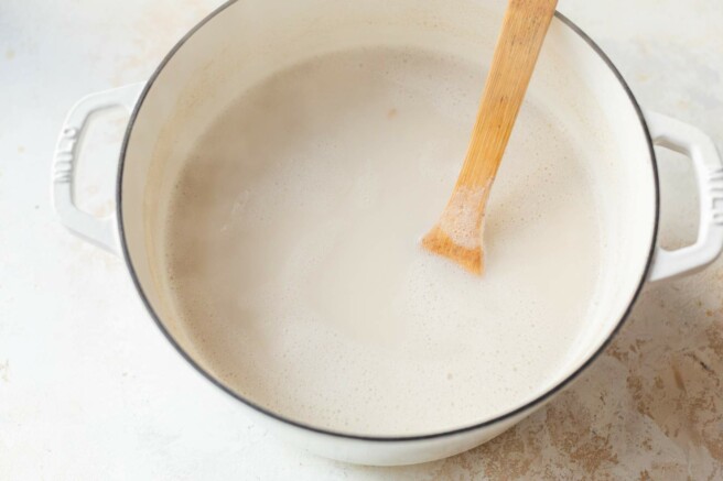 Bringing steel cut oats to a boil in a large pot.