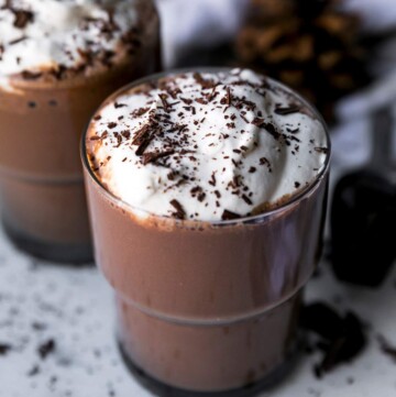 Protein hot chocolate topped with whipped cream and chocolate shavings.