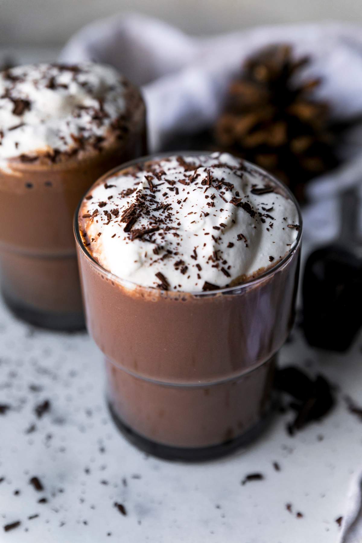Protein hot chocolate topped with whipped cream and chocolate shavings.