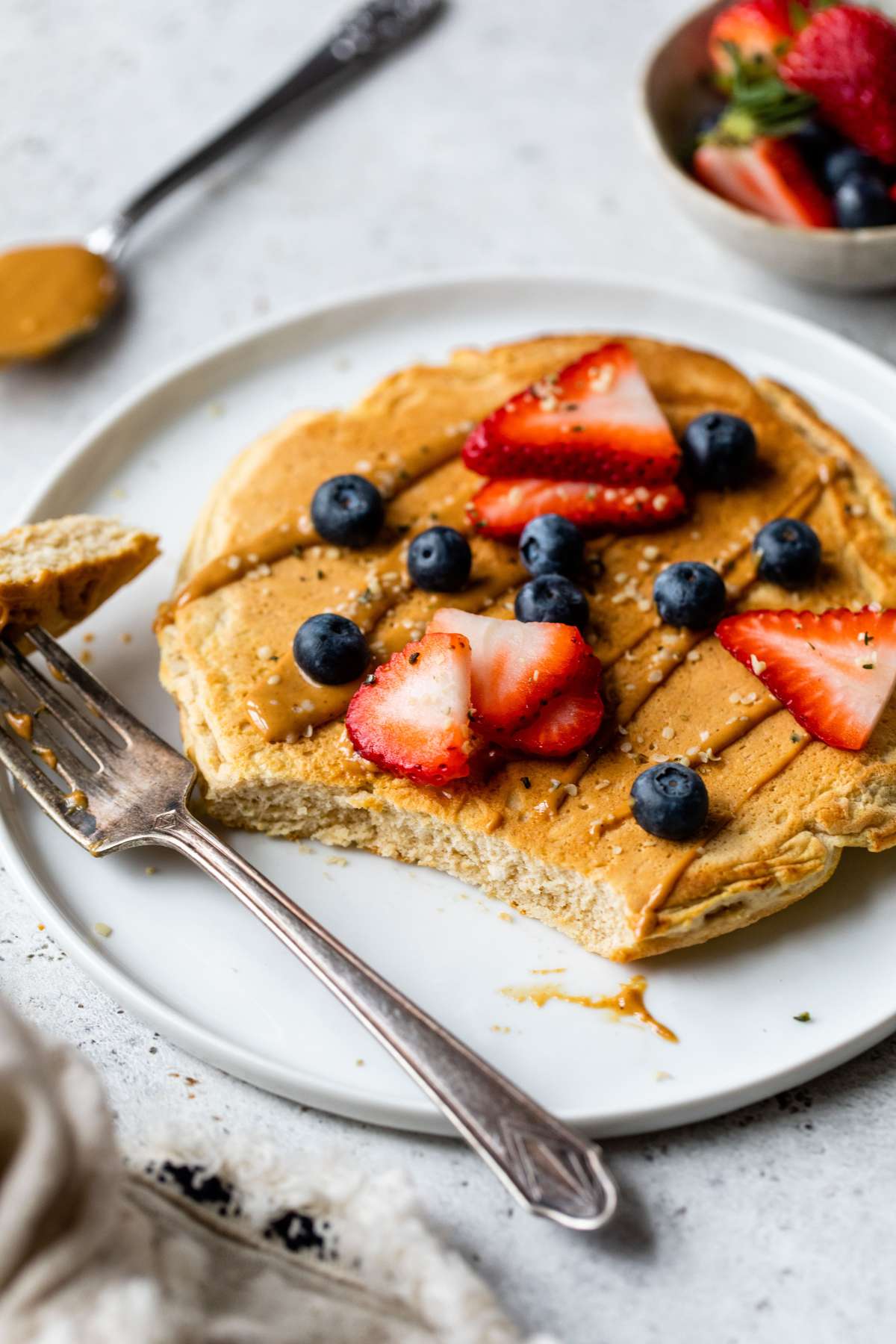 Pancake with a bite taken out with a fork.