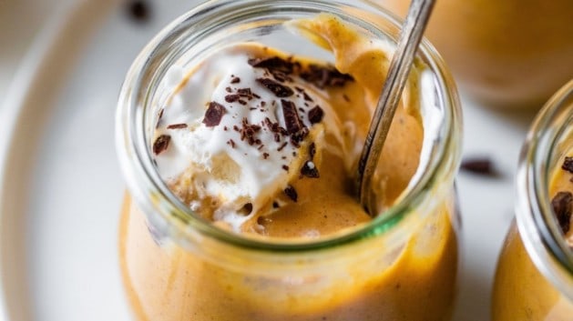 pumpkin mousse served in a small glass jar with a spoon
