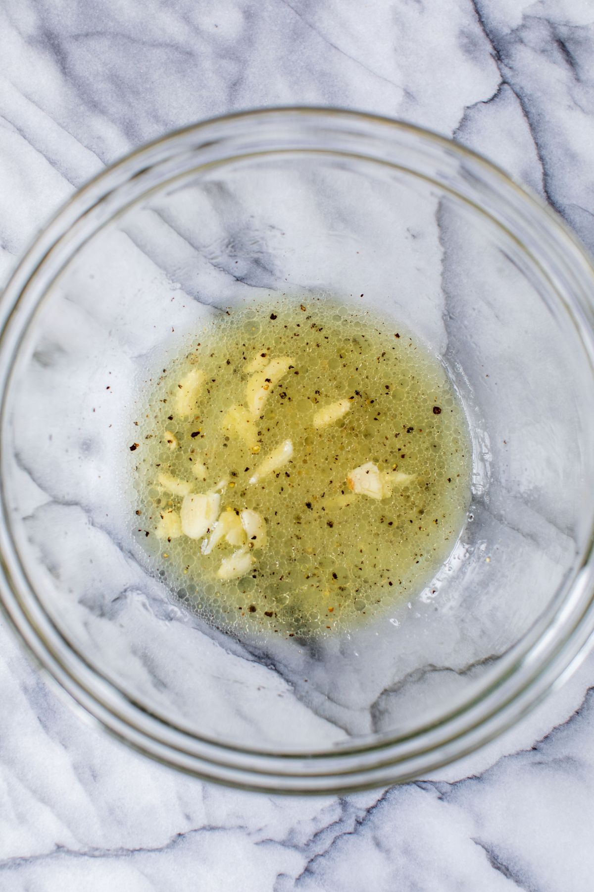 Making a vinaigrette in a large bowl.