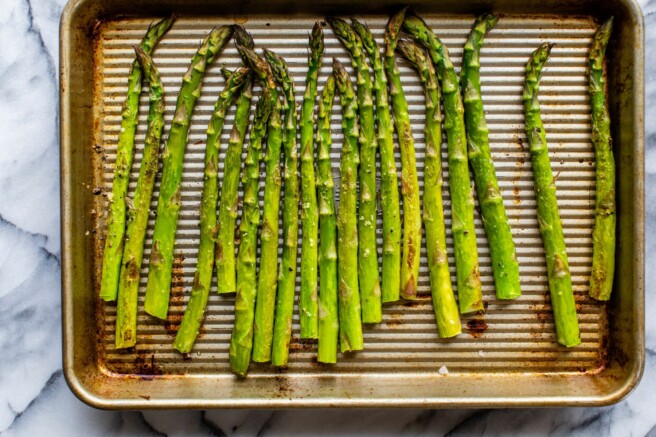 Asparagus spears on a sheet pan.