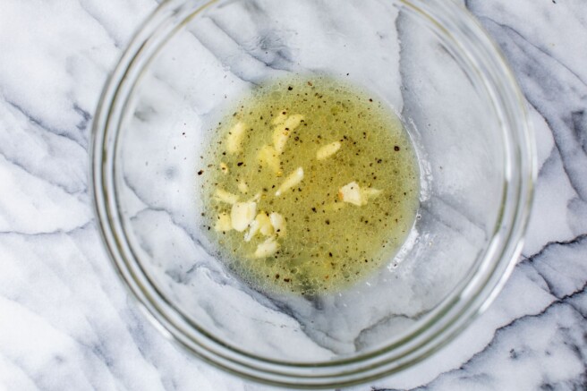 Making a vinaigrette in a large bowl.