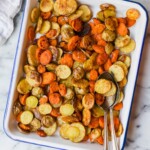 Roasted carrots and baby potatoes on a serving tray.