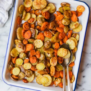 Roasted carrots and baby potatoes on a serving tray.