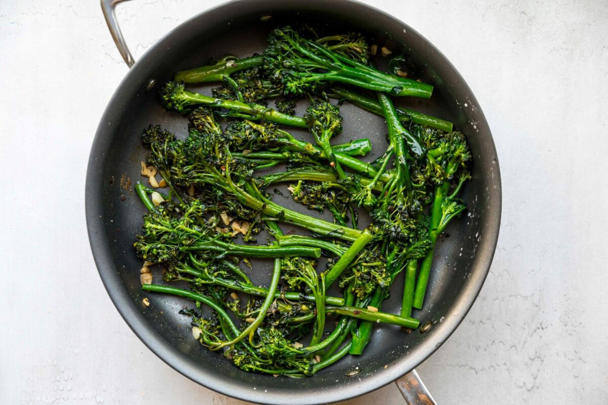 Sautéed broccolini in a large pan.