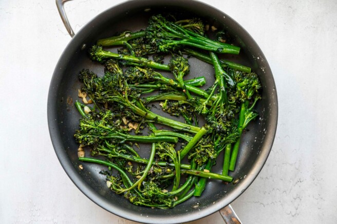 Sautéed broccolini in a large pan.