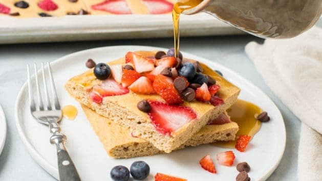 sheet pan pancakes drizzled with maple syrup