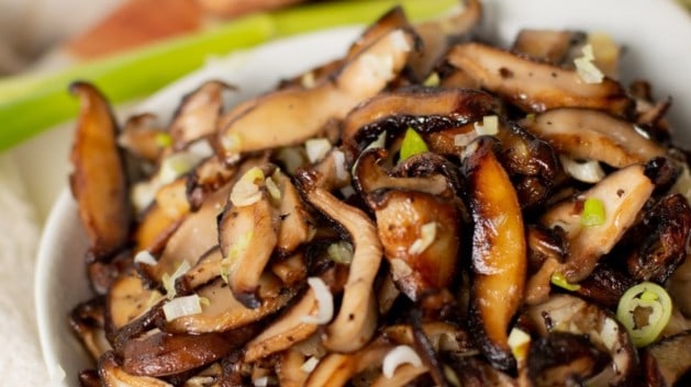 sautéed shiitake mushrooms in a small white bowl