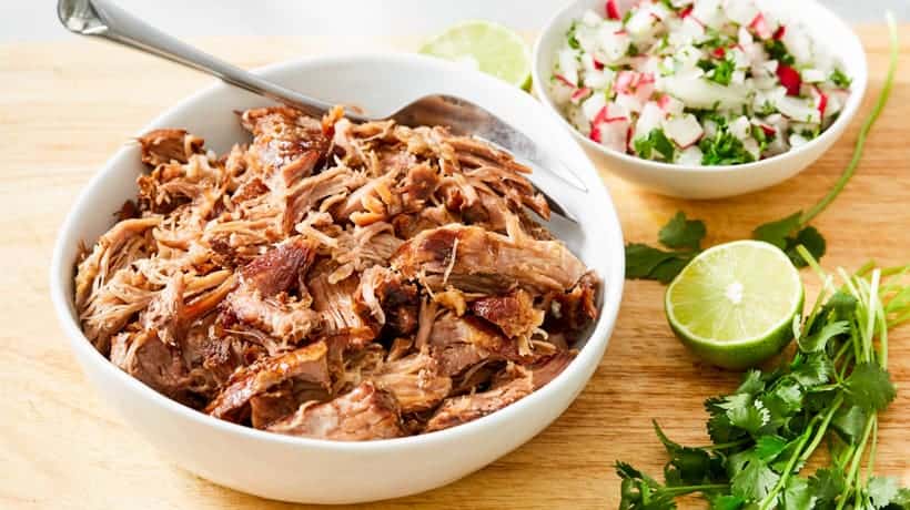 shredded kaluha pork in bowl with salsa